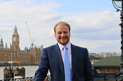 Thomas Gravatt with the Houses of Parliament in the background